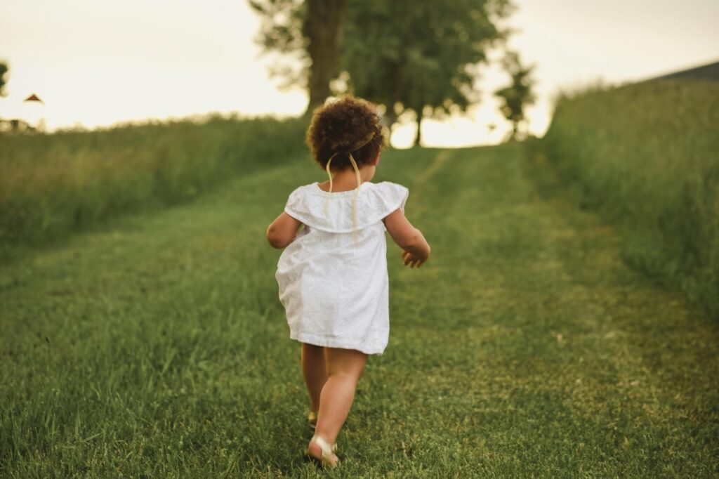 A young girl on a grass field