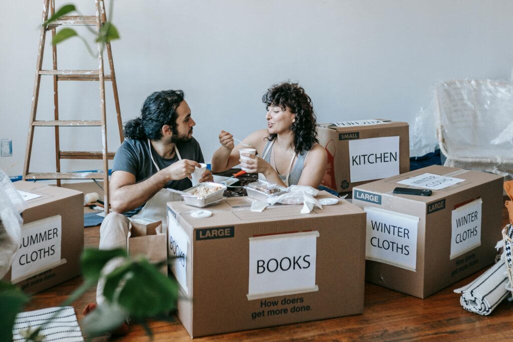 A couple is having a meal after moving in in the concept of things to consider when relocating to Leyton.