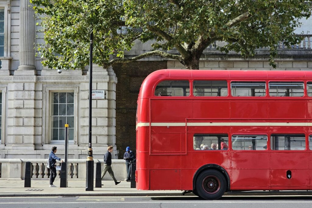 A double-decker is picking up passengers